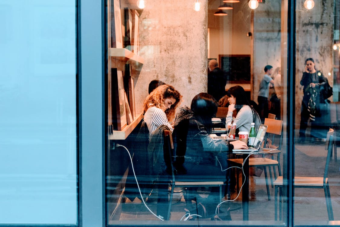 women in cafe using technology